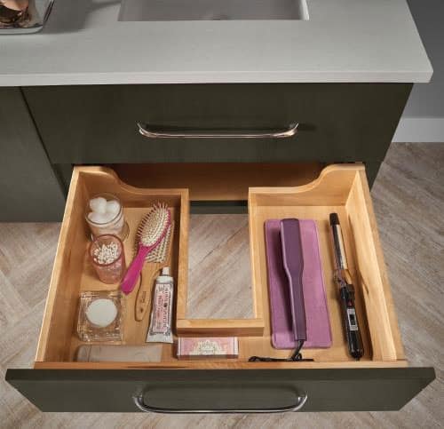 kraftmaid open drawer under vanity with toiletries and hairstyling products