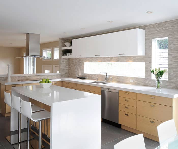 remodeled kitchen in light, natural colors with two-toned cabinetry, white upper cabinets and light wood lower cabinets