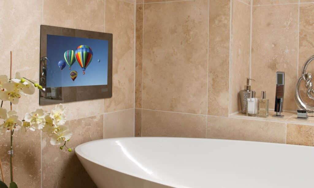 built-in tv next to standing tub in remodeled bathroom