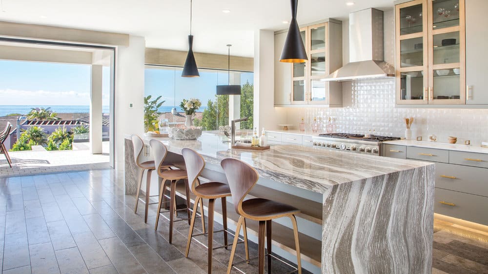 bright coastal kitchen with quartz countertops open to patio