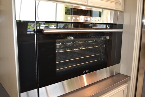 wall-mounted stainless steel oven with touchscreen